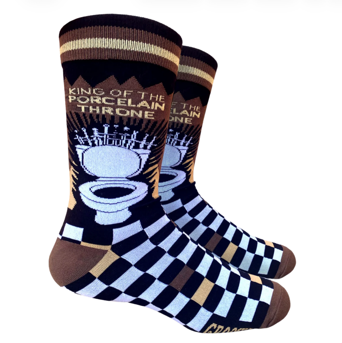 A pair of novelty crew socks featuring a black and white checkerboard pattern on the lower half, brown and beige stripes at the cuff, and a graphic of a toilet crowned with swords with the text 'KING OF THE PORCELAIN THRONE'.