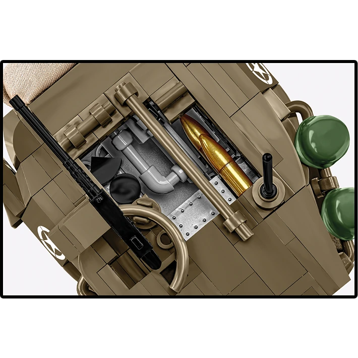 A photo of the top of the tank, its hatch is open, showing details of the interior, featuring visible golden artillery shells. Two green soldiers' helmets sit on the side of the tank.