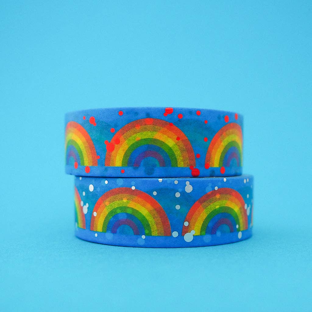 2 rolls of Washi tape, blue with a repeated pattern of rainbows, one with pale blue dots the other with red dots