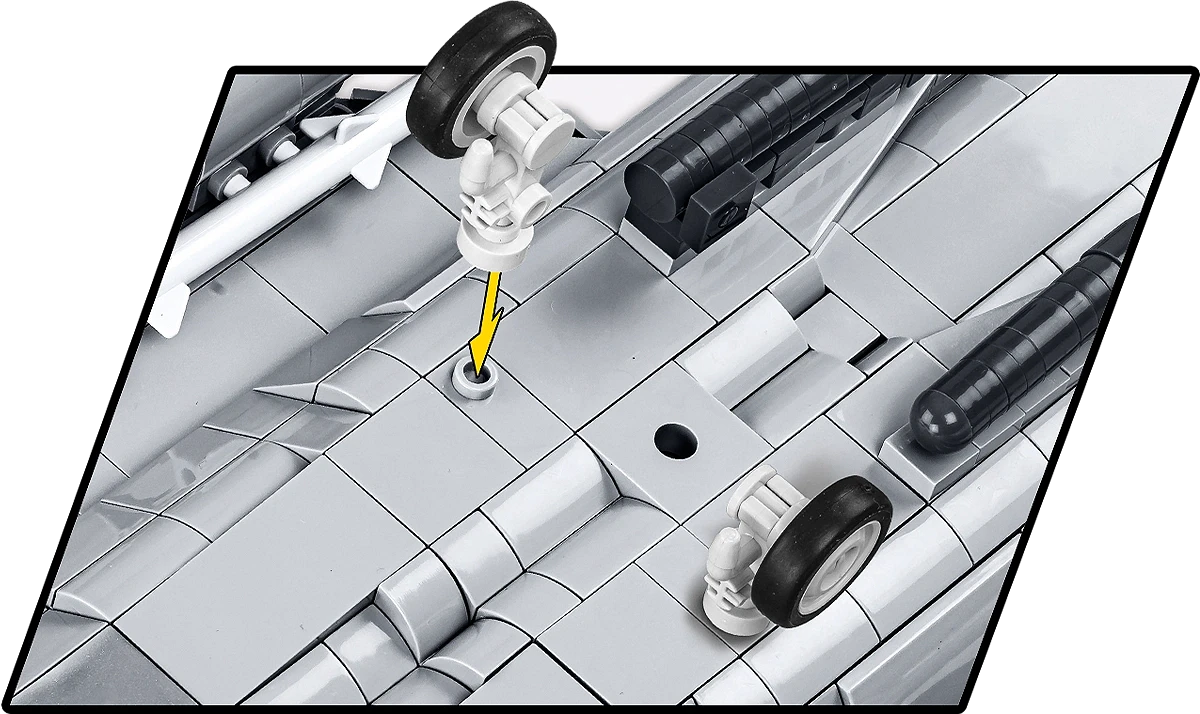 A close-up of the underside of the model. One of the landing gears is removed, with an arrow showing how it can be easily attached to a hole on the bottom of the aircraft.