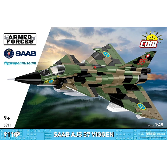 The retail box for the model, showing a picture of the assembled aircraft on a blurred background of some hills and the sky, creating the implication that the aircraft is flying through the air. The manufacturer’s logo is displayed in the top right corner. The ARMED FORCES branding and the logo of the aircraft are displayed on a white diagonal section on the left, and a blue strip across the bottom of the box displays the number of pieces, specific name of the tank, its scale, and small warning label.