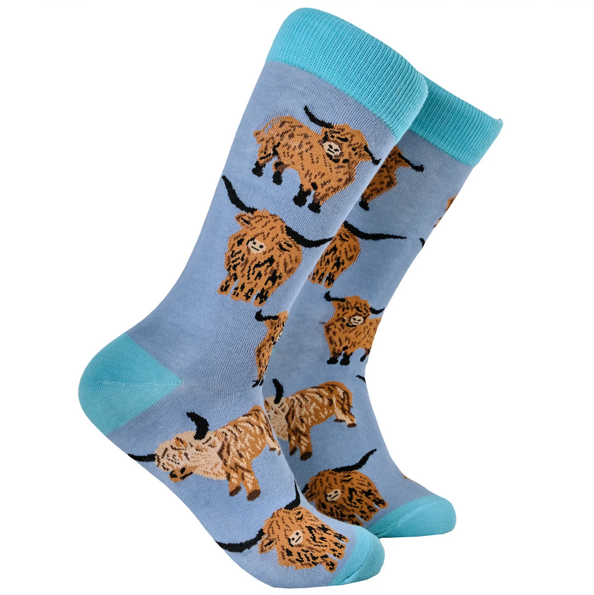 A pair of light blue crew socks featuring a repeating pattern of brown highland cows with black horns, finished with bright turquoise ribbed cuffs, heels, and toes, shown against a plain white background.