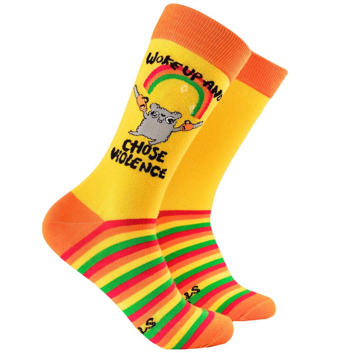 A pair of novelty crew socks on a plain white background. The socks are primarily yellow with bright orange cuffs and heels, and feature a graphic of a gray cartoon character holding a rainbow above the text 'WAKE UP AND CHOSE VIOLENCE'.