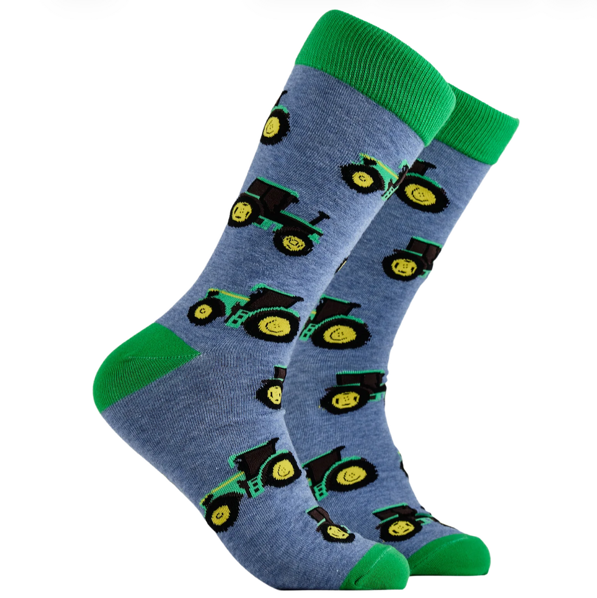 A pair of crew socks in denim blue-gray with a green, black, and yellow tractor pattern, featuring solid green cuffs, heels, and toes, displayed on a white background.