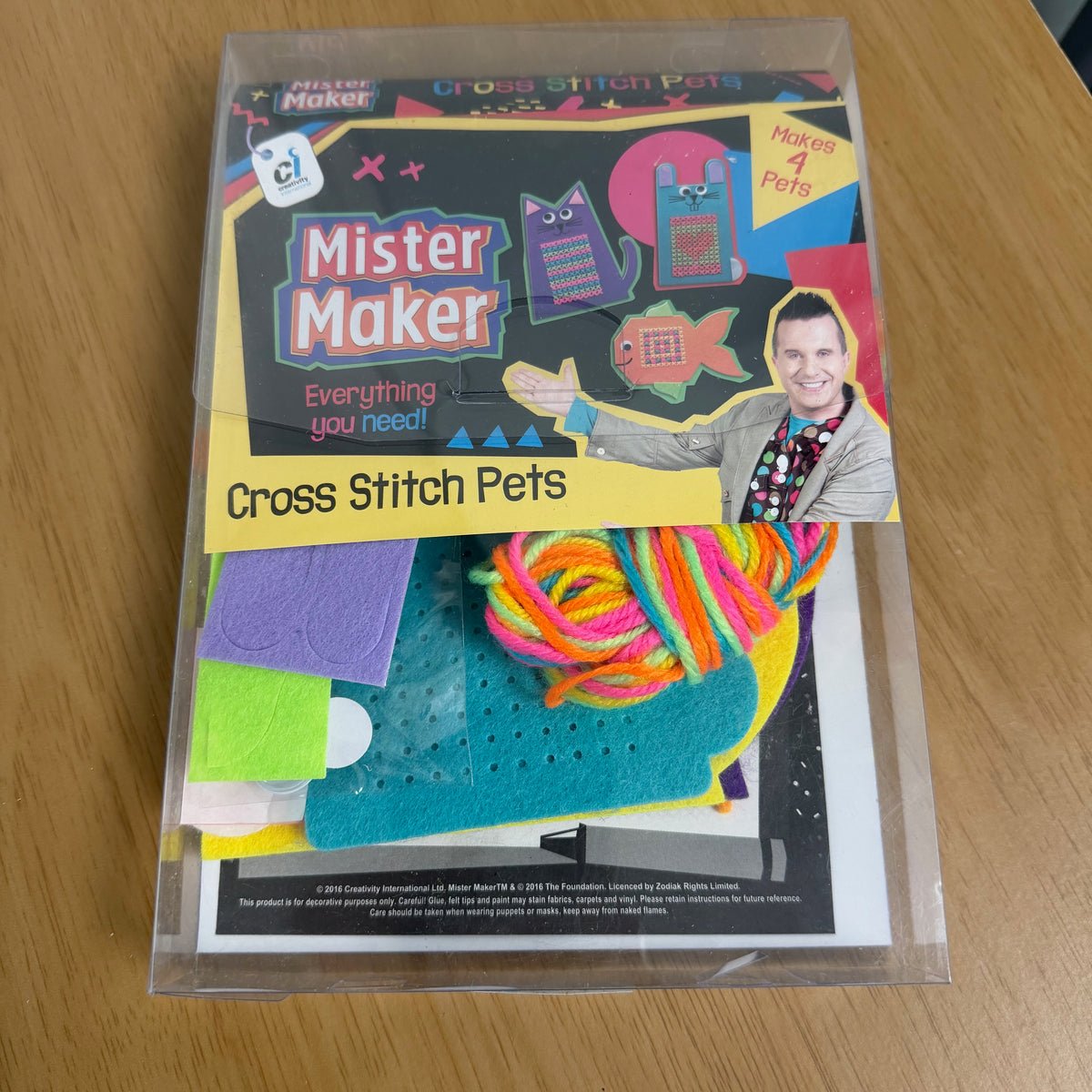 Picture showing the front of the packaging, featuring a picture of Mister Maker and examples of the cross stitch that can be made.