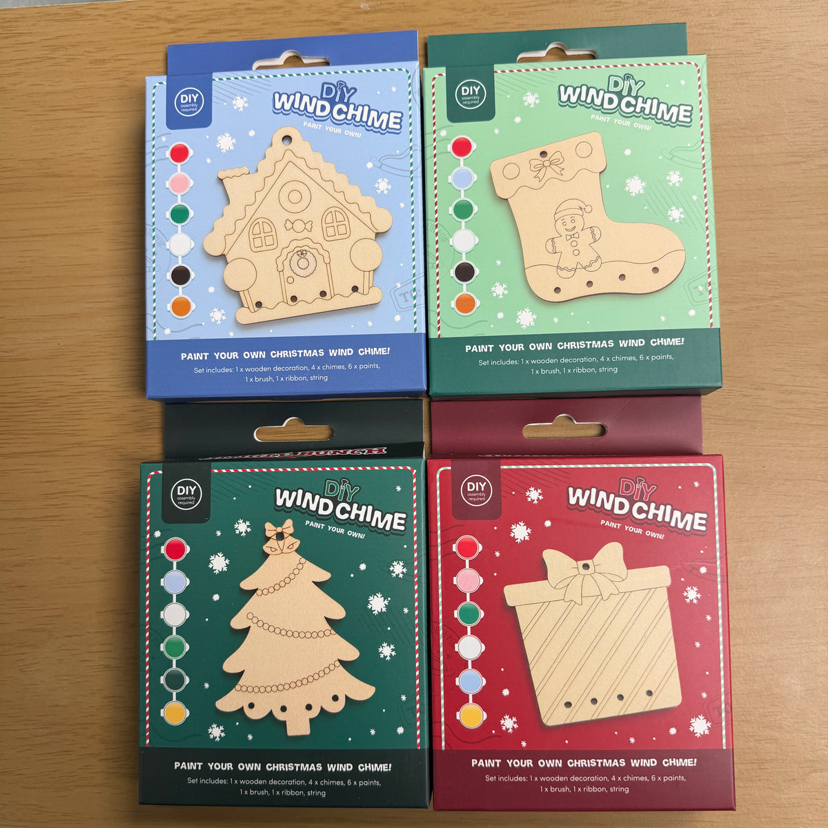 A picture showing the four variants of the wind chime decoration, a gingerbread house, a stocking, a tree and a present.