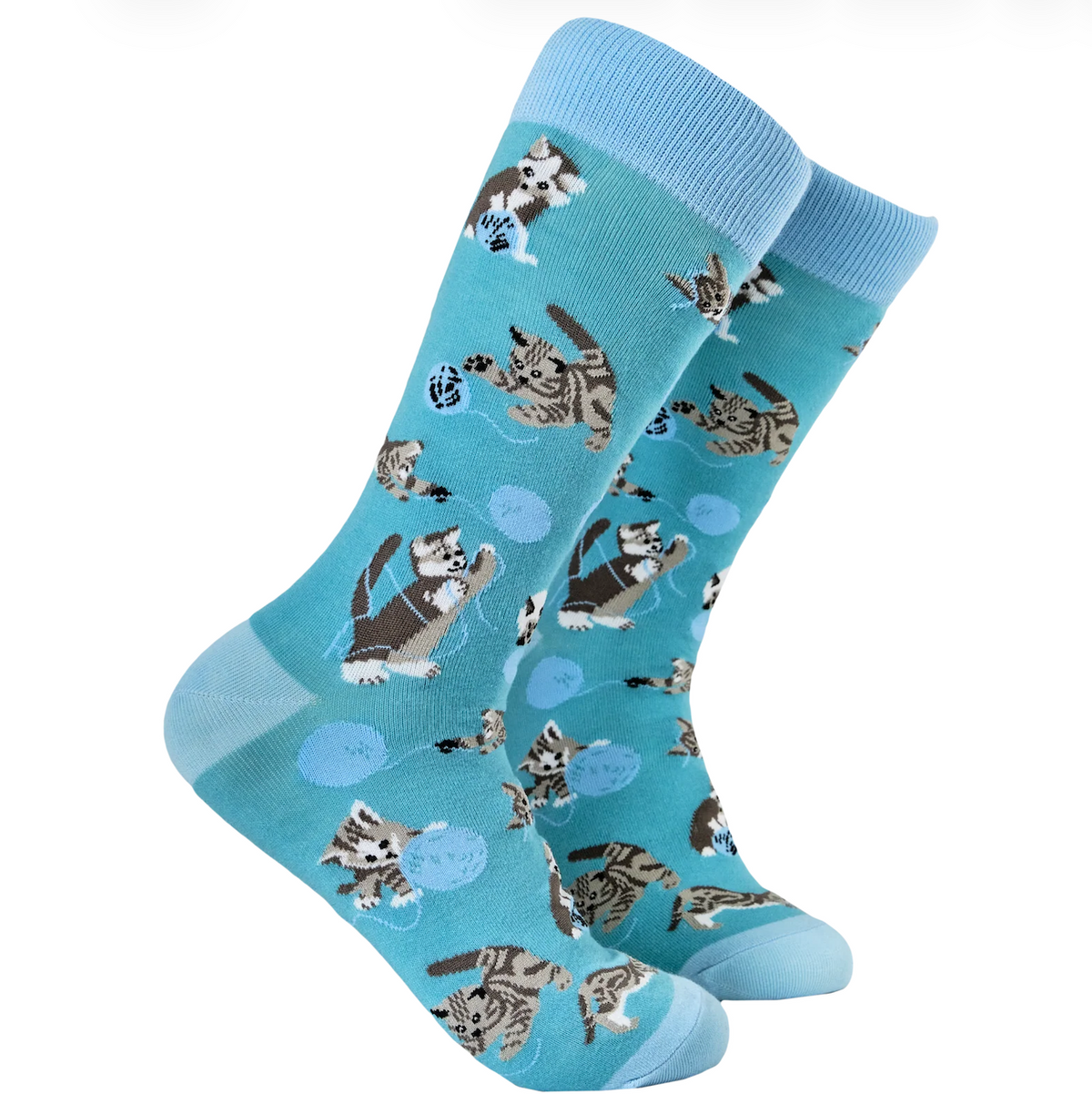 A pair of light blue crew socks with a playful pattern of kittens chasing blue yarn balls, shown against a plain white background.