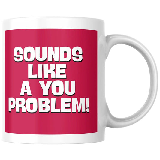 A white ceramic mug featuring a bold magenta-pink square graphic on the front with the text 'SOUNDS LIKE A YOU PROBLEM!' in large white letters with black outlines.